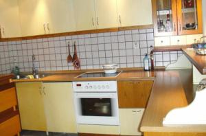 a kitchen with a white stove top oven next to a sink at Lovely house with garden at an excellent location! in Agria