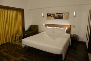 Voodi või voodid majutusasutuse Lemon Tree Hotel Coimbatore toas