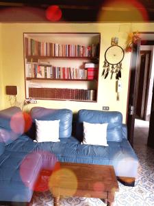 ナポリにあるGoldenCube Guest Houseのリビングルーム(コーヒーテーブル付)の青いソファ