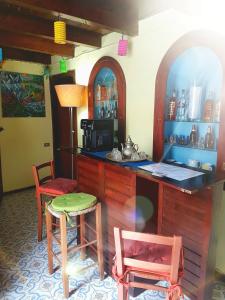 a kitchen with a counter and a table and chairs at GoldenCube Guest House in Naples