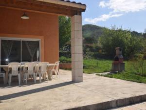 a table and chairs sitting outside of a house at Luxurious Villa in Thueyts with Private Pool in Thueyts