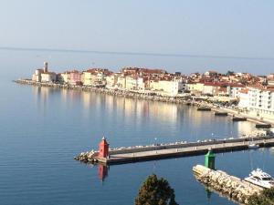 a harbor with a red lighthouse in the middle of the water at Apartments Mirjana in Piran