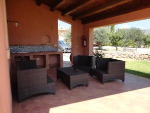 a patio with a bar with chairs and a table at La Taverna in Floridia