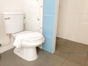 a bathroom with a toilet with a towel on it at TK residence in Kalasin