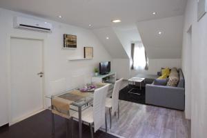 a living room with a table and a couch at Villa Toni Design Apartments in Split