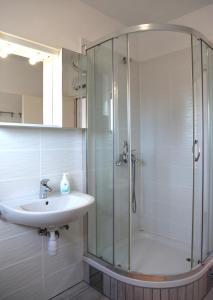 a bathroom with a sink and a shower at Apartments Laura in Pinezici +23 photos
