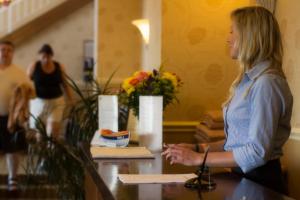 Una mujer parada en un mostrador en una habitación. en Bay View - Seafront, Sandown, Isle of Wight, en Sandown 24 fotos más