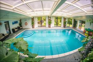 an indoor swimming pool with a large ceiling at Sea View Holiday Flat - Covehurst Bay in Hastings