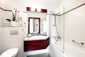 a bathroom with a sink and a shower at Hotel Atrium in Szczecin