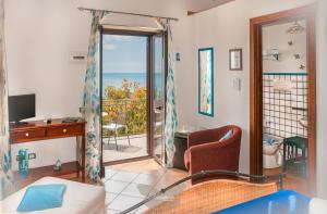 a room with a bedroom with a view of the ocean at B&B Mariposa in Maratea