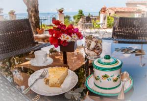 a table with a piece of cake and a plate of food at B&B Mariposa in Maratea