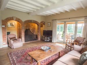 a living room with a table and a fireplace at The Brewhouse in Doddington