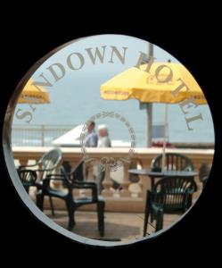 a view of a table and chairs and an umbrella at The Sandown - Seafront, Sandown, Isle of Wight - CAR FERRY TICKET from 109 Pounds in Sandown