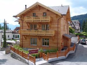 a large wooden house with a balcony on it at Chalet Balthazar in Villars-sur-Ollon