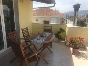 a table and chairs on the balcony of a house at Aquarella Apartment in Chrysoupolis