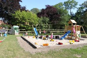 a playground with children playing in the sand at Ferienhof BauerMüller in Fehmarn +17 photos