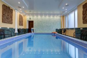 a large swimming pool in a large room at Borodino Hotel in Moscow