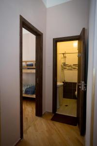a door leading into a room with a bathroom at Guesthouse Hillside in Tbilisi City +37 photos