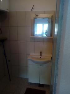 a bathroom with a sink and a window at setenčić in Trebinje