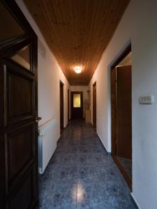 an empty hallway with a wooden ceiling and a door at Apartment Barica in Smoljanac