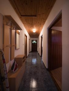 a hallway with a wooden ceiling and a long corridor at Apartment Barica in Smoljanac