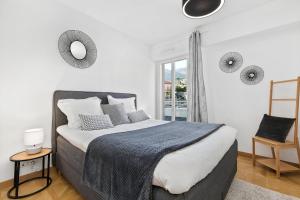 a bedroom with a large bed and a window at Luxury Monaco Sea View Penthouse Le Lord in Beausoleil