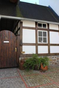 a barn with a wooden door and some plants at Eifel-Quartiere "Pension Müscher Bahnhof" in Müsch +7 photos