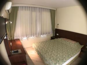 Postel nebo postele na pokoji v ubytování Ataer Hotel