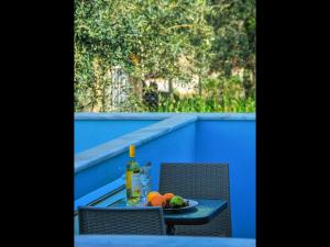 a table with a bottle of wine and a plate of fruit at Pan Mare in Skala Sotiros