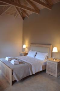 a bedroom with a large bed with two night stands at Aligis Studios in Katelios