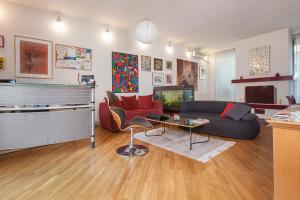 a living room with a couch and a tv at Urban Hostel & Apartments in Skopje