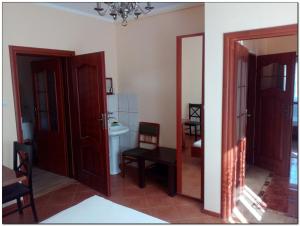 a room with two doors and a bathroom with a sink at Rodzinny dom. in Augustów +26 photos