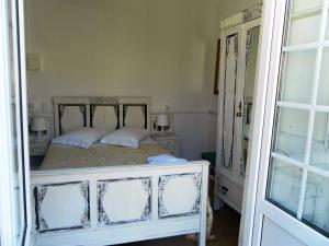 a bedroom with a white bed with two pillows at New Aljubarrota Guest House in Lisbon