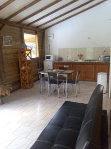 a kitchen and dining room with a table and chairs at La Belle Creole in Morne-à-lʼEau