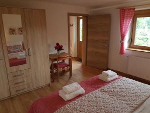 a bedroom with two towels on a large bed at Apartment Eden Bled in Bled