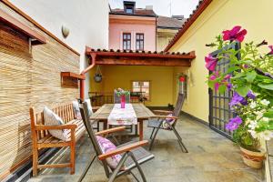 a patio with a wooden table and chairs at Historic Centre Apartments VII in Prague