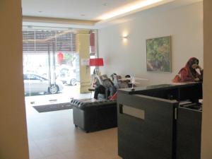 a woman sitting in a waiting room at a salon at Fargo Boutique Hotel in Kuantan