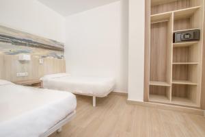 Postel nebo postele na pokoji v ubytování Apartamentos Lago