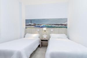 Postel nebo postele na pokoji v ubytování Apartamentos Lago