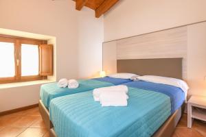 A bed or beds in a room at Residence Corte Ferrari -Ciao Vacanze-