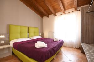 A bed or beds in a room at Residence Corte Ferrari -Ciao Vacanze-