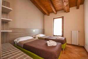 A bed or beds in a room at Residence Corte Ferrari -Ciao Vacanze-