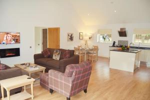 a living room with a couch and a table at Endymion Lodge in Colchester