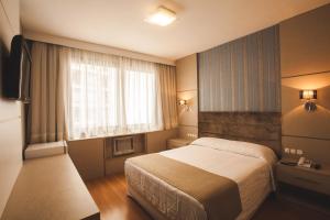Postel nebo postele na pokoji v ubytování Curitiba Palace Hotel + 37 fotografií