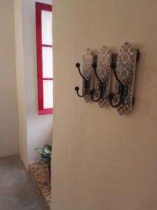 a wall with a candle holder on a wall with a window at Vallettastay Casa Zoe in Valletta