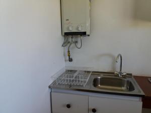 a small kitchen with a sink and a sink at Cabañas M y M Frutillar in Frutillar +21 photos