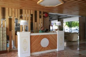 a man sitting at a counter in a restaurant at Maren Beach Apart Hotel in Alanya