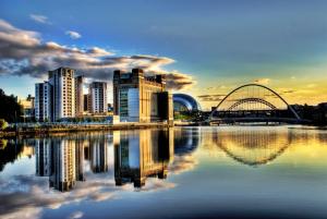 a city with buildings and a bridge over a body of water at Grey Street Hotel in Newcastle upon Tyne