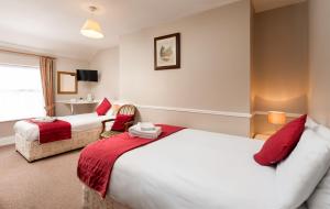 a hotel room with two beds and a window at Abbott Lodge in Dublin