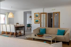 a living room with a couch and a table at Cabot Villa Sa Sini in Port de Pollensa